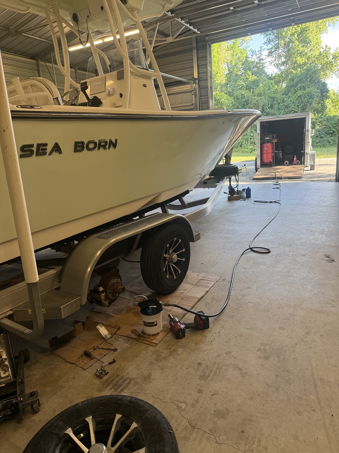 Boat trailer undergoing wheel and hub service by TNS Trailers